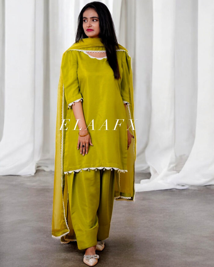 A stunning parrot green piece outfit made from Indian raw silk, designed with a delicately embellished inner featuring beadwork, puffy organza sleeves, a classic farshi shalwar, and a 3-yard organza dupatta.